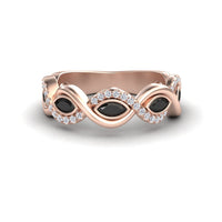 The Selma Black & White Diamond Infinity Twist Band features a rose gold infinity loop with three marquise black stones and white diamond accents, beautifully displayed on a white background.