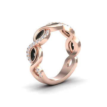 The Selma Black & White Diamond Infinity Twist Band is a rose gold ring with marquise black stones and round white diamonds set along its elegant twist design.
