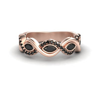 The Black Diamond Infinity Twist Band - Selma is a rose gold ring with a twisted band, featuring marquise-shaped black stones and small black stones set along its curves.