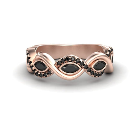 The Black Diamond Infinity Twist Band - Selma is a rose gold ring with a twisted band, featuring marquise-shaped black stones and small black stones set along its curves.