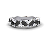 The Black & White Diamond Zigzag Eternity Band - Aimee features a silver design with alternating rectangular black stones and round and marquise-cut clear stones in a striking crisscross pattern.