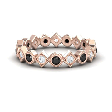 The Black & White Diamond Geometric Eternity Band - Hetal is a rose gold ring with alternating black and white diamonds set in geometric square and circular bezels, arranged in a repeating pattern around the band.