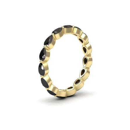 The Black Diamond Stackable Eternity Band - Kalyani features oval black gemstones set all around the gold band, displayed on a white background.