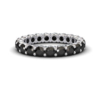 The Black Diamond Prong-Set Eternity Band - Mahira features round black stones set all around its silver band, shown against a white background.