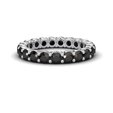 The Black Diamond Prong-Set Eternity Band - Mahira features round black stones set all around its silver band, shown against a white background.