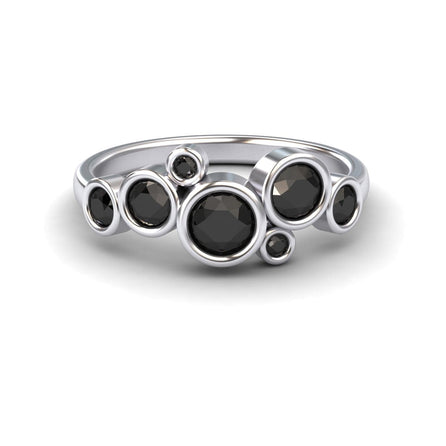 The Black Diamond Bubble Ring - Carmen features seven round black diamonds in varying sizes, each set in a bezel and arranged in an asymmetrical, clustered design.