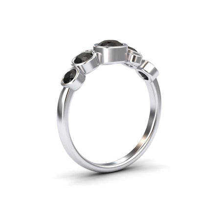 The Black Diamond Bubble Ring - Carmen features five round black diamonds of varying sizes in an asymmetrical silver setting, shown on a plain white background.