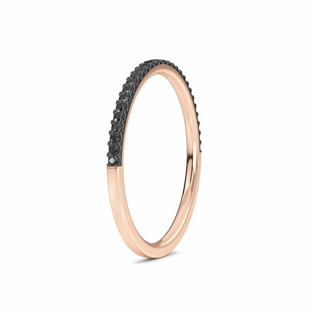 The Black Diamond Pave Half Eternity Band Ring - Stephanie is a slim rose gold band with a row of small round black diamonds set along the top half, displayed against a white background.