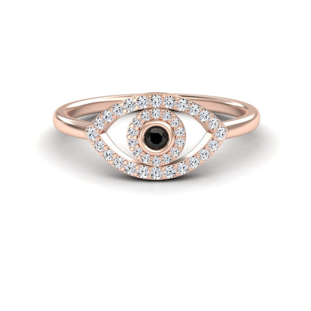 The Black & White Diamond Evil Eye Ring - Hazel is a gold ring with an eye design, featuring a black center stone encircled by small white diamonds.
