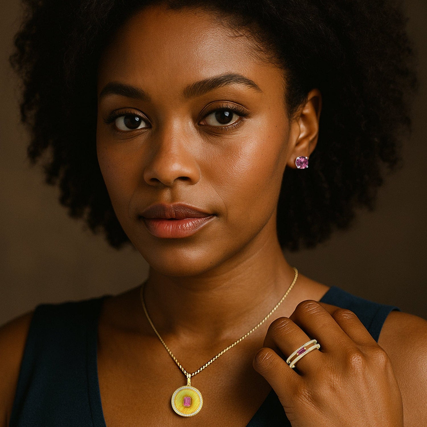 Woman wearing jewelry including a necklace, earrings, and rings against a dark background