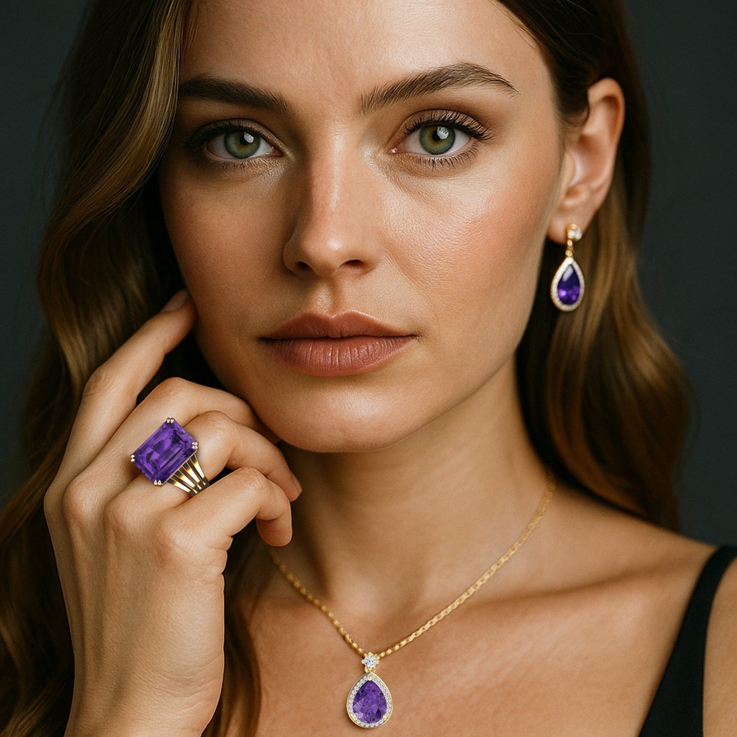 Woman wearing purple gemstone jewelry including earrings, ring, and necklace against a dark background