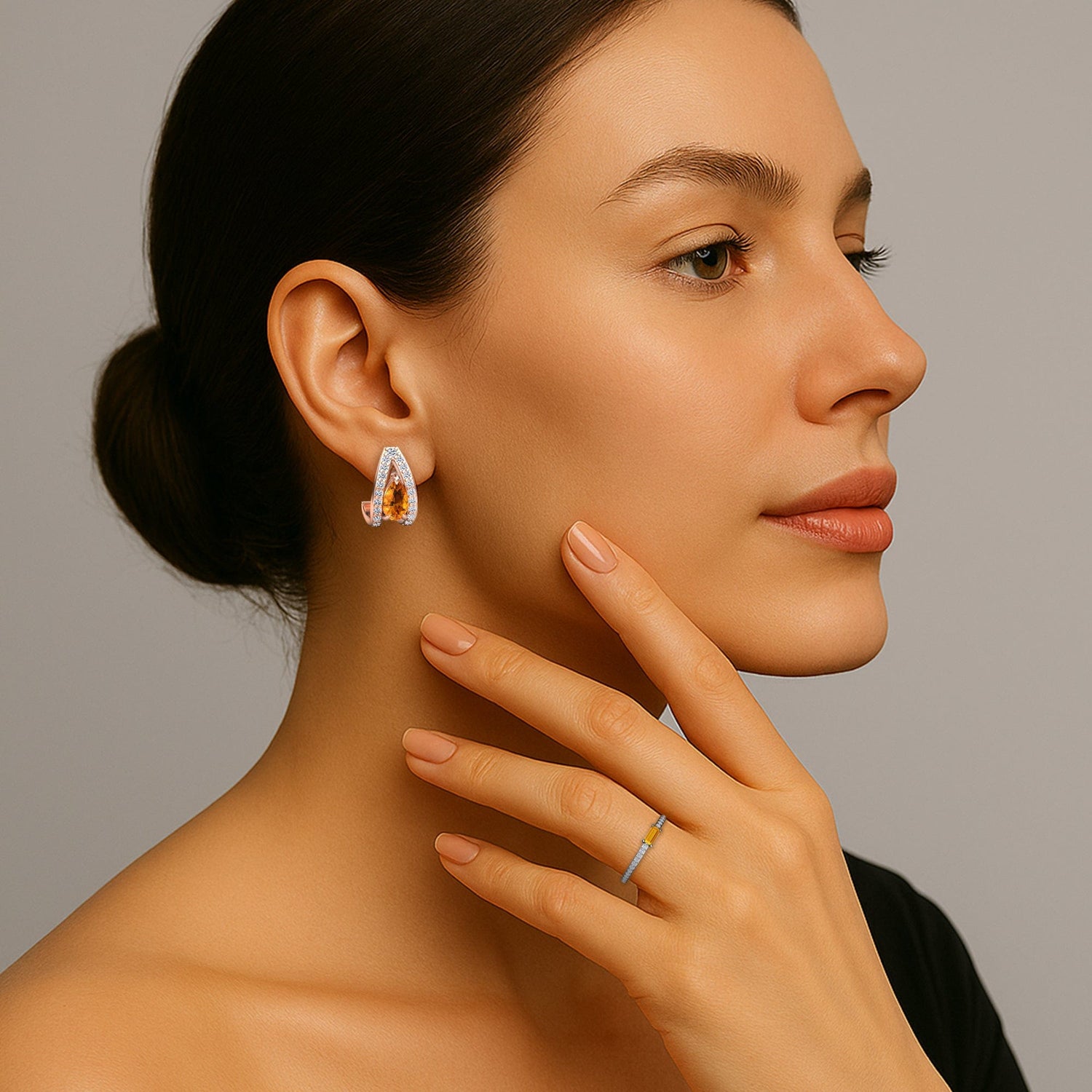 Woman wearing citrine earrings with a neutral background
