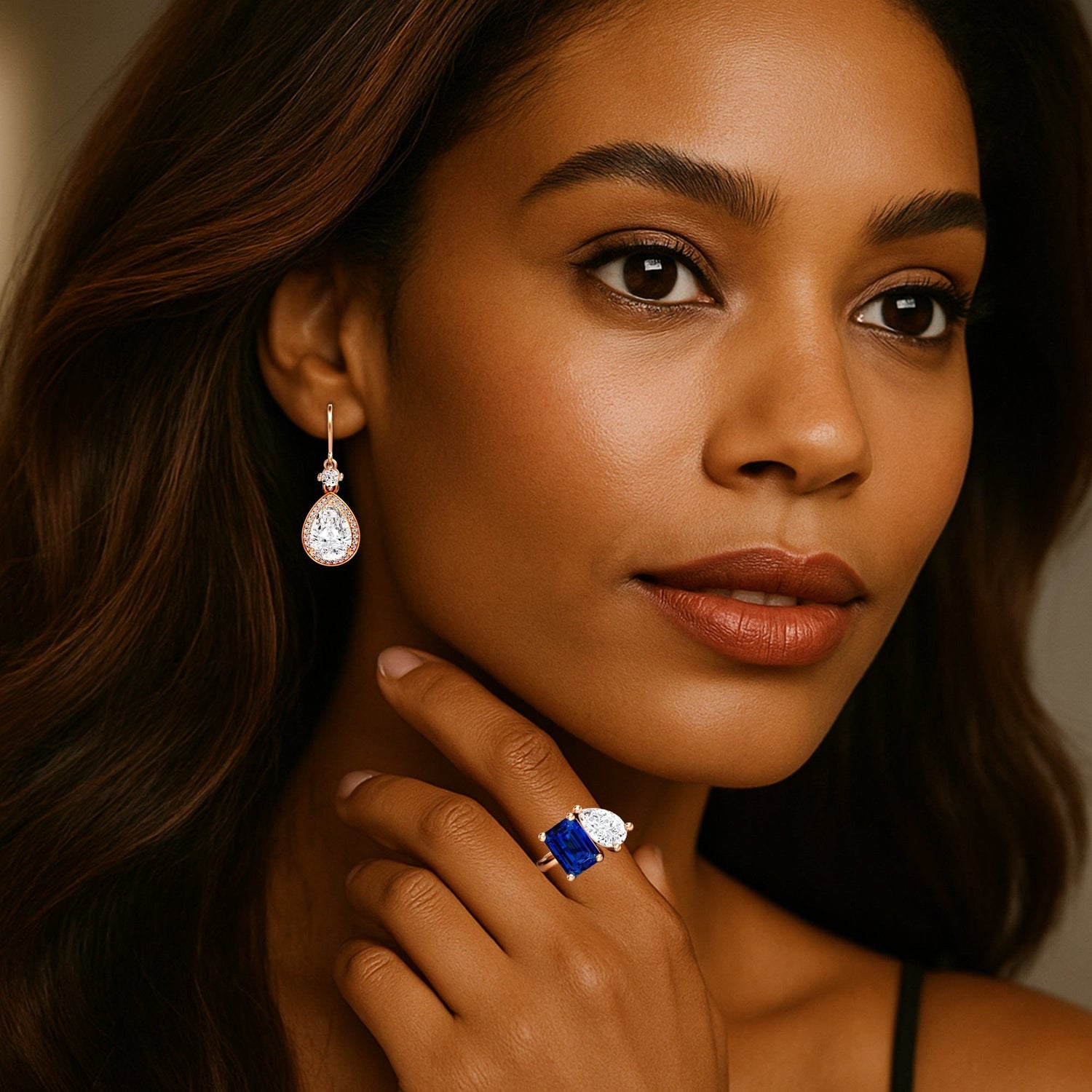 Woman wearing a lab grown diamond gemstone ring and diamond earring, with a neutral background