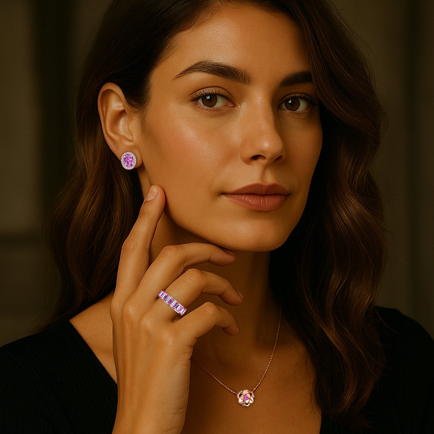Woman wearing pink sapphire gemstone earrings and ring, with a blurred background