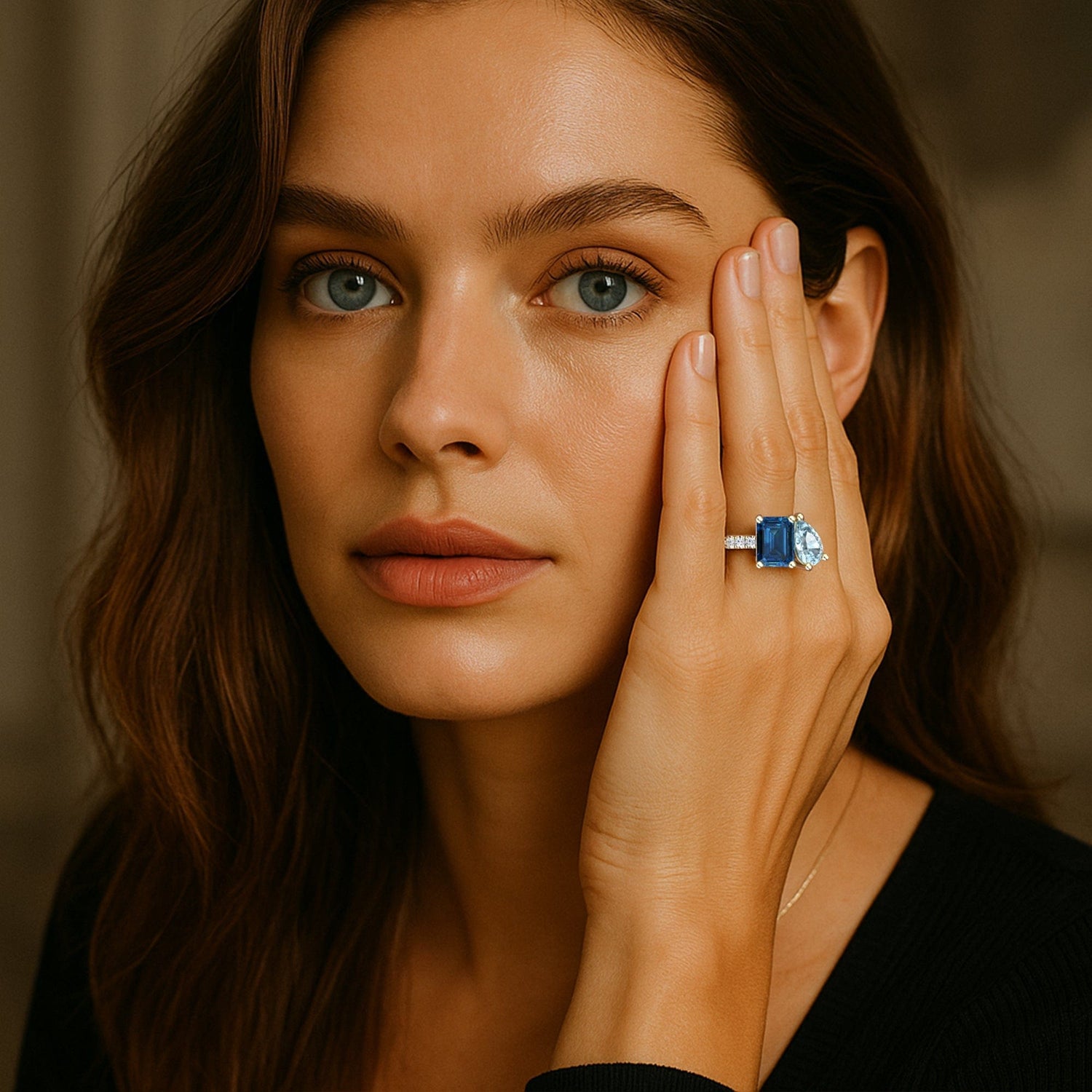 Woman wearing a London Blue Topaz gemstone ring on her hand, with a blurred background