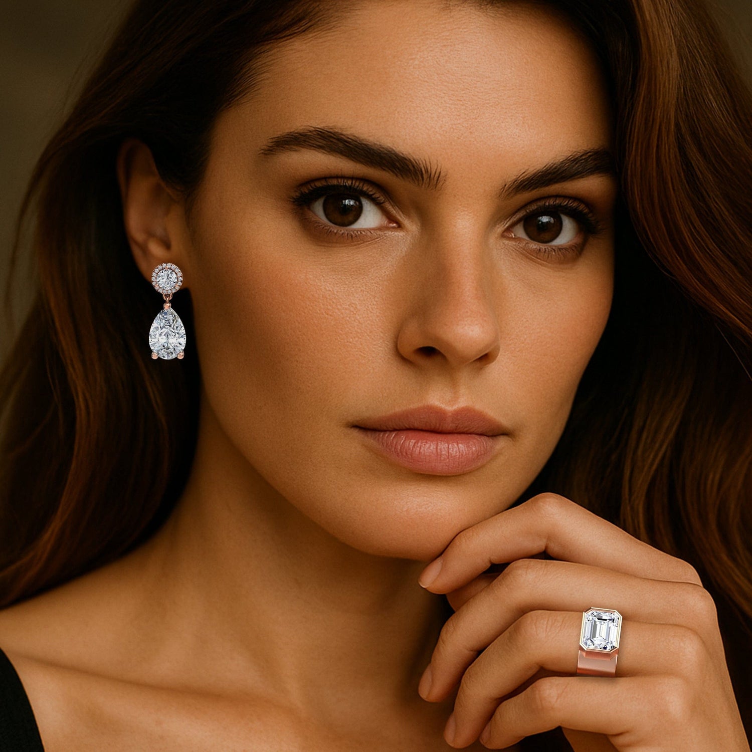 Woman wearing lab grown diamond earrings and ring, close-up of face and hand.