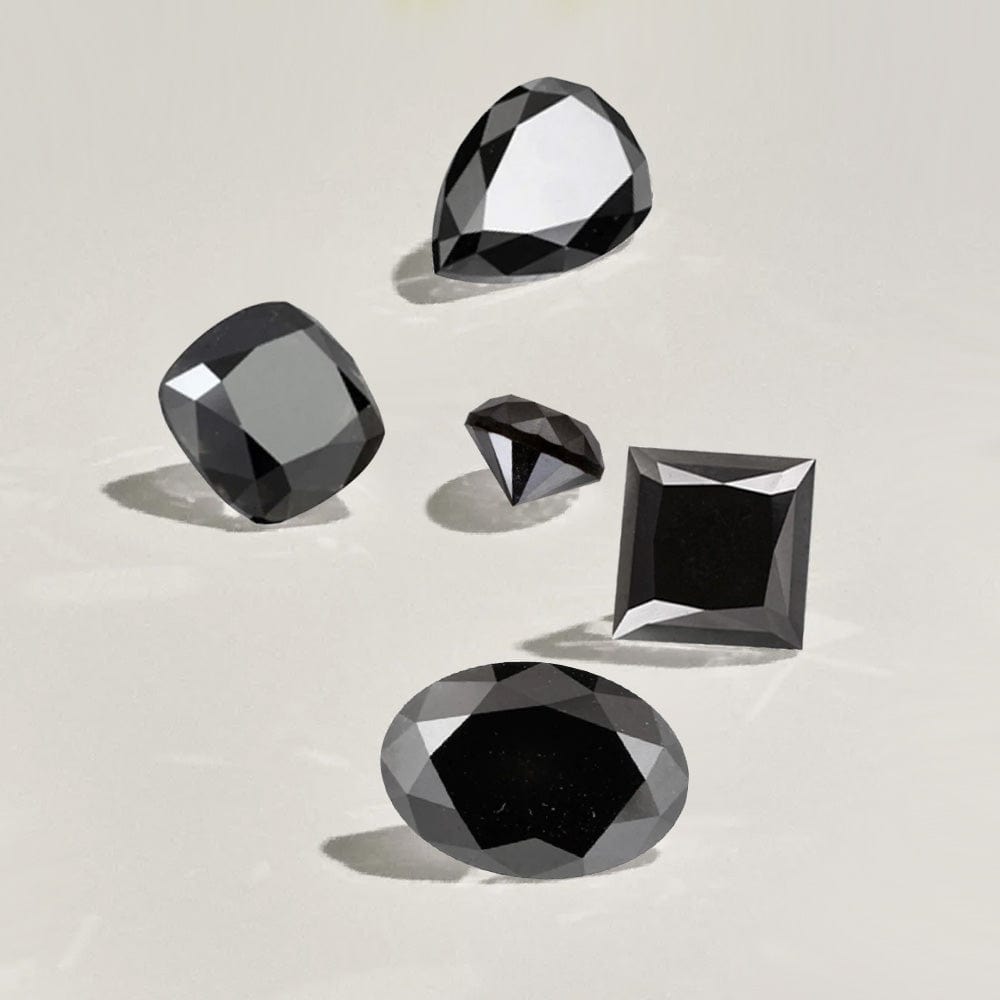 Five black diamonds of different shapes on a light beige background
