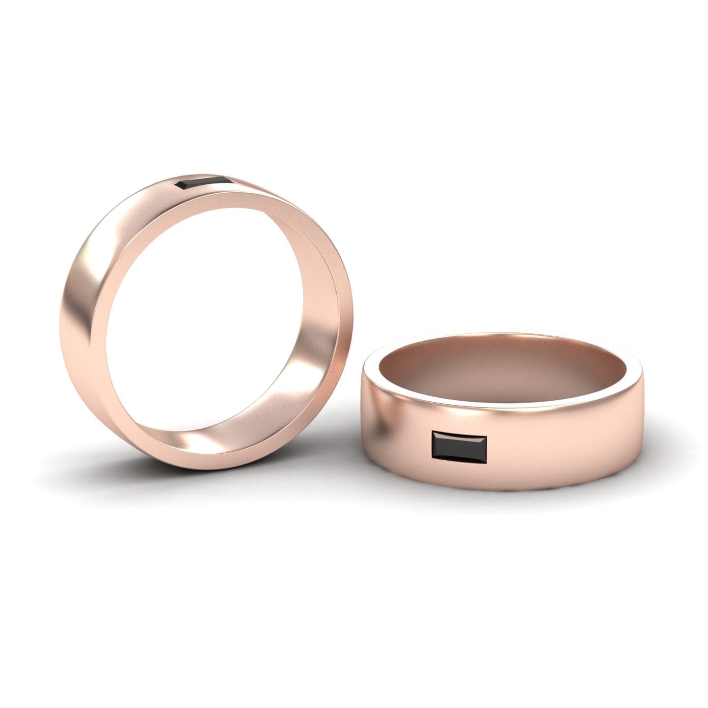 Two Black Diamond Solitaire Men’s Band Rings - Nayana are displayed on a white background; one stands upright while the other lies flat, both showcasing a distinctive rectangular setting on the band.