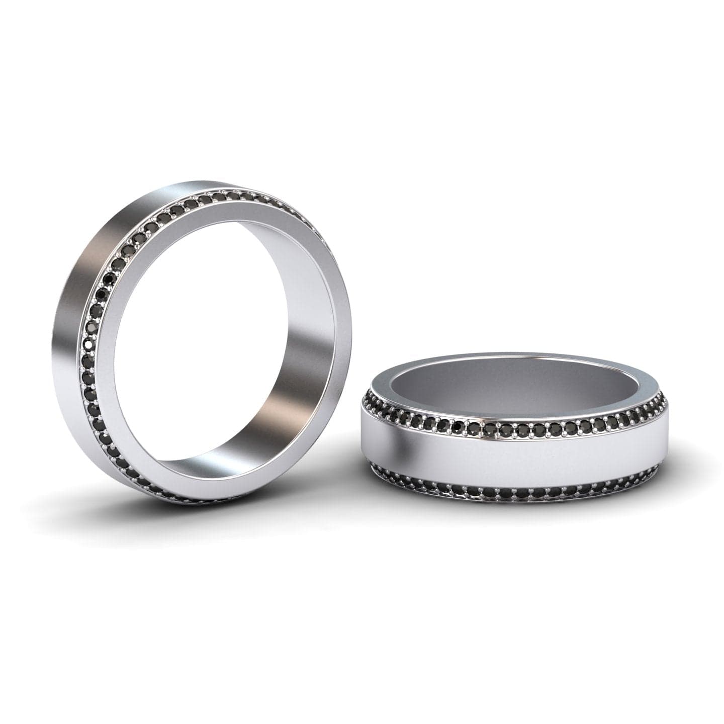 The Black Diamond 6mm Eternity Wedding Ring - Caleb, featuring a row of small black stones set in silver, is shown on a white background—one ring upright and the other lying flat.