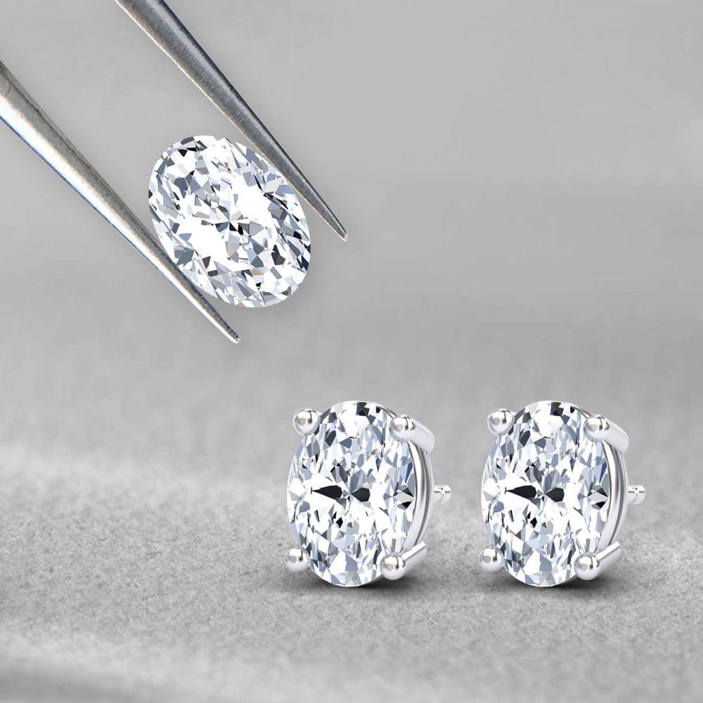Pair of diamond stud earrings on a gray background