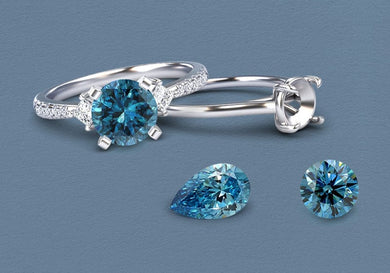 Silver ring and earrings with blue diamond gemstones on a gray background