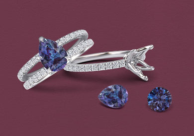 Silver ring with lab grown alexandrite gemstones on a maroon background