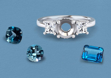 Silver ring with london blue topaz gemstones on a blue background