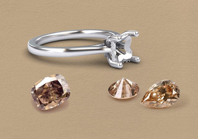 Silver ring with three brown diamond gemstones on a beige background