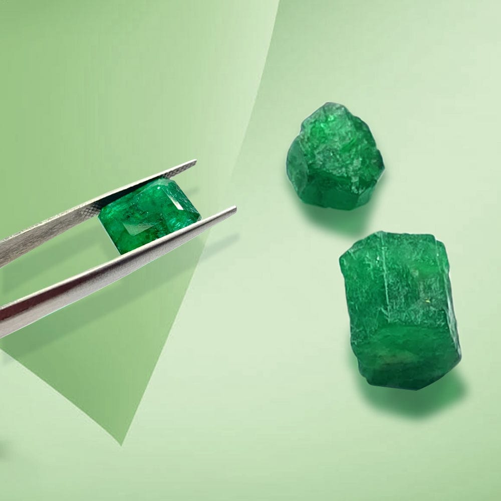 Two rough emeralds and a faceted emerald on a light green background