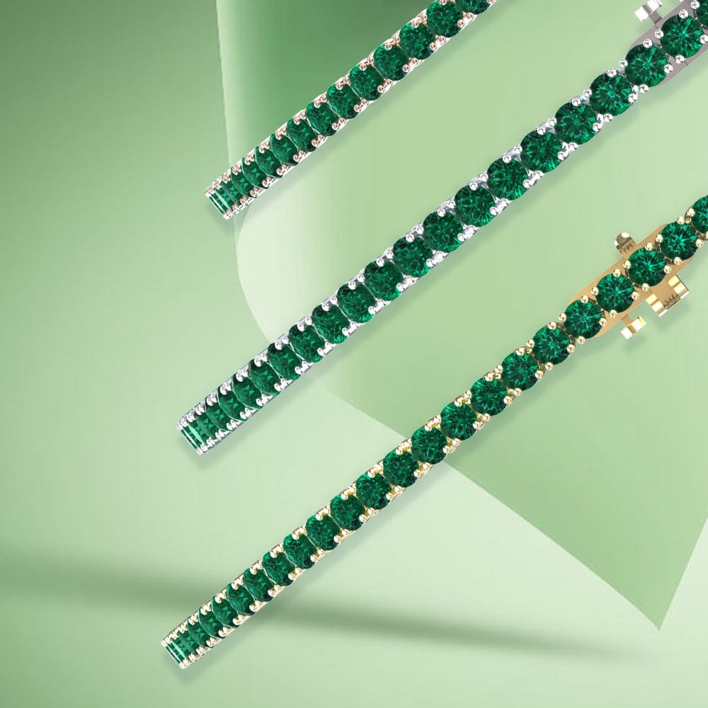 Two green emerald gemstone bracelets on a light green background