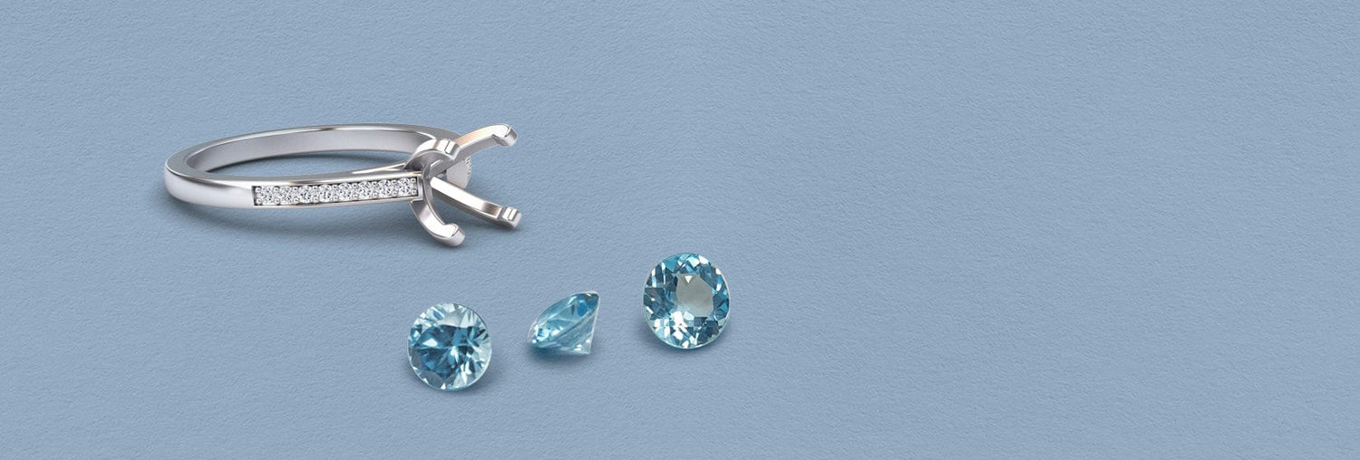 Aquamarine ring — March birthstone, Silver ring with diamond accents and three blue gemstones on a light blue background