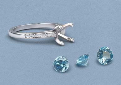 Aquamarine ring — March birthstone, Silver ring with diamond accents and three blue gemstones on a light blue background