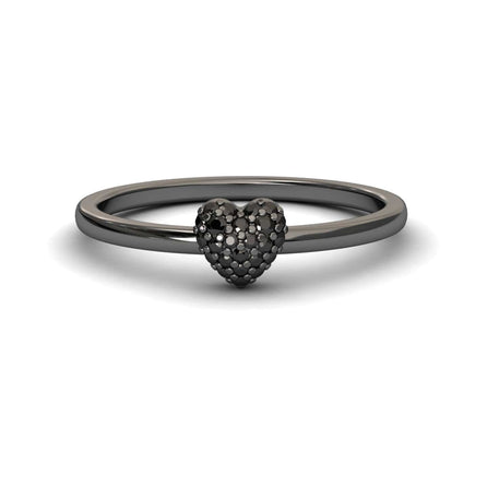 The Black Diamond Pave Heart Ring - Bonita is a sleek, thin black metal ring with a textured heart centerpiece encrusted with tiny dark stones, shown on a white background with a subtle shadow.