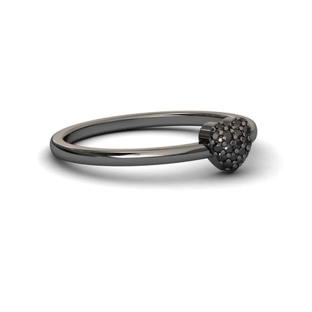The Black Diamond Pave Heart Ring - Bonita is a sleek black metal ring with a small, textured heart adorned with sparkling pave stones on top, shown against a white background.