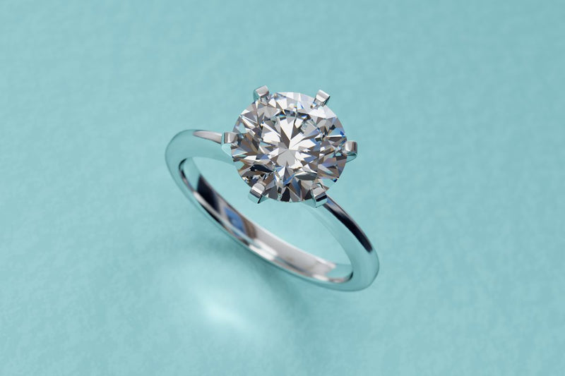 A close-up of a solitaire diamond engagement ring.