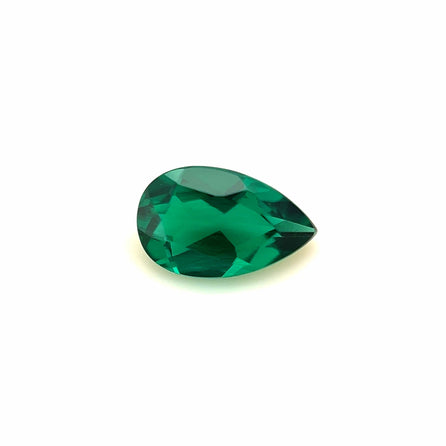 The 8x5 Exceptional Pear Zambian Color Lab Created Emerald, expertly faceted and lab created, is showcased against a plain white background.