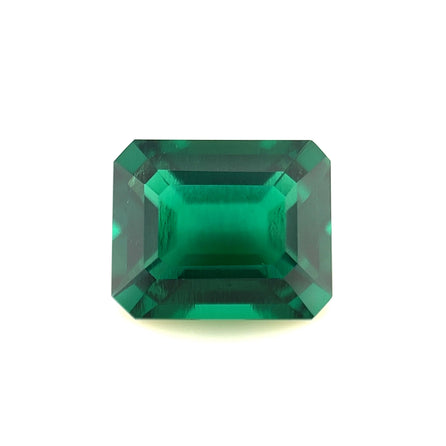 An 11x9 exceptional Zambian color lab-created emerald with a rectangular, emerald cut and beveled edges, shown against a white background.