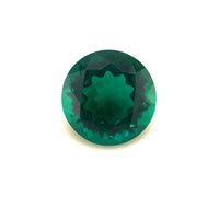 The 10mm Exceptional Round Zambian Color Lab Created Emerald, expertly faceted with a deep green hue, is shown against a plain white background.