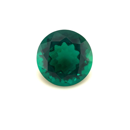 The 10mm Exceptional Round Zambian Color Lab Created Emerald, expertly faceted with a deep green hue, is shown against a plain white background.