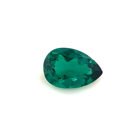 The 9.0x6.0 Exceptional Pear Zambian Color Lab Created Emerald, with vibrant translucent green color, is displayed against a plain white background.