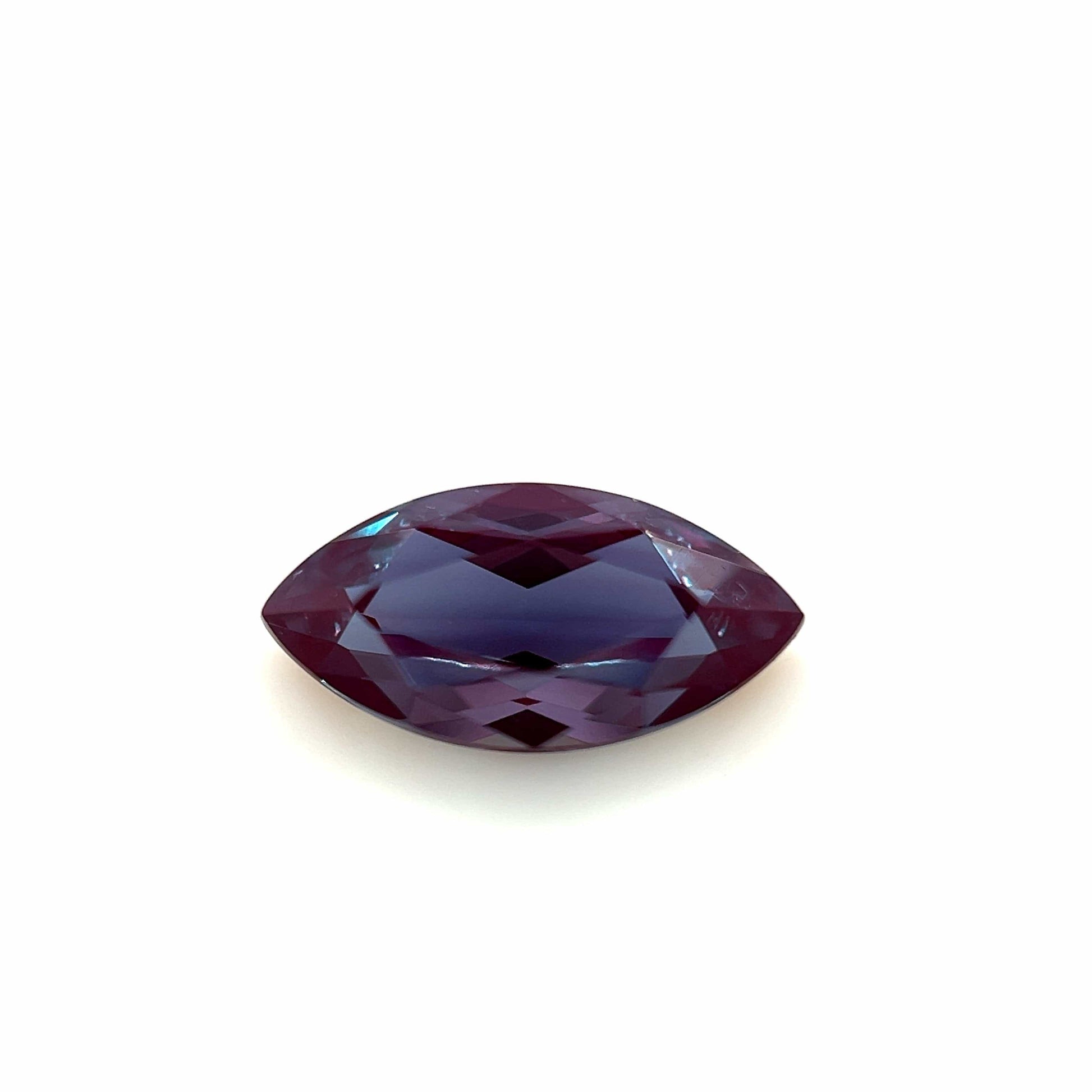 The 10.0x5.0 Exceptional Marquise Lab Created Alexandrite features a deep purple, faceted gemstone displayed on a white background.