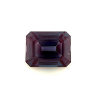 A 10.0x8.0 exceptional emerald-cut lab created Alexandrite with deep purple hues and sharp facets is displayed against a plain white background.