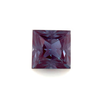 A 6mm Exceptional Square Princess Lab Created Alexandrite, with a deep purple hue and faceted surface, is shown against a plain white background.