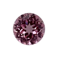 A 10.00-10.00 mm Premium Round Padparadscha, a faceted natural gemstone with a vivid pinkish-purple hue, reflects light to reveal intricate internal patterns against a plain white background.