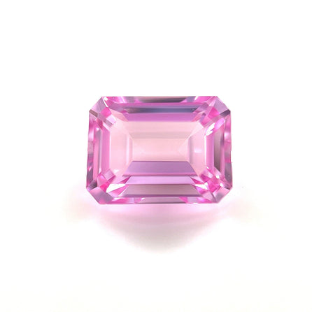 An 8.0x6.0 Exceptional Emerald Lab Created Medium Pink Sapphire with beveled edges is displayed on a white background, reflecting light and showcasing medium pink hues with intricate facets.