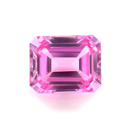 The 10x8 Exceptional Emerald Lab Created Medium Pink Sapphire features sharp facets and a bright, reflective surface, displayed from above on a white background.