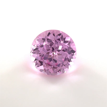 The 8mm Exceptional Round Lab Created Medium Pink Sapphire features a brilliant cut and medium pink hue, elegantly displayed on a white background.