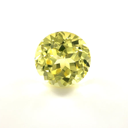 The 9.5mm Exceptional Round Synthetic Yellow Sapphire is shown against a plain white background, highlighting its brilliant sparkle and intricate faceting.