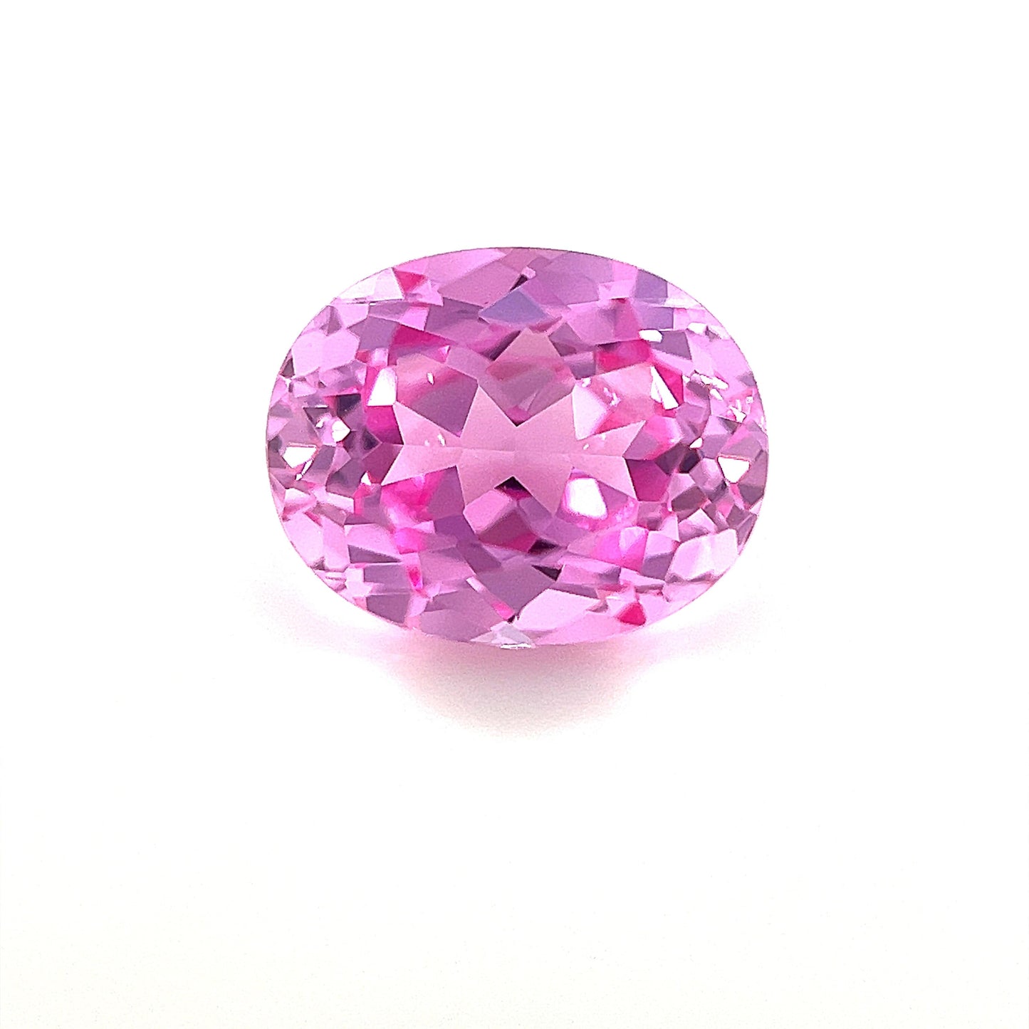 An exceptional 10.0x8.0 oval lab-created medium pink sapphire with a sparkling surface is displayed on a plain white background.