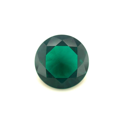 The 12mm Exceptional Round Zambian Color Lab Created Emerald is displayed against a plain white background, highlighting its exquisite faceting and brilliant deep green hue.